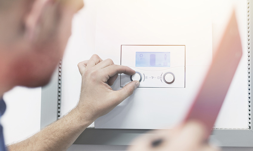 a person turning off the water heater