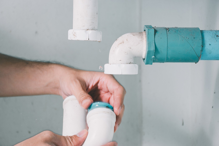 a person fixing the pipes