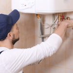 a technician installing a tankless water heater