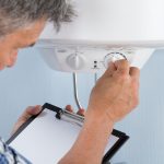 plumber holding a clipboard while doing an inspection