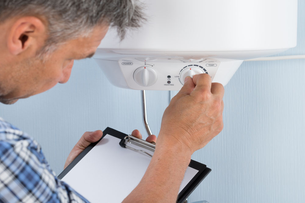 plumber holding a clipboard while doing an inspection